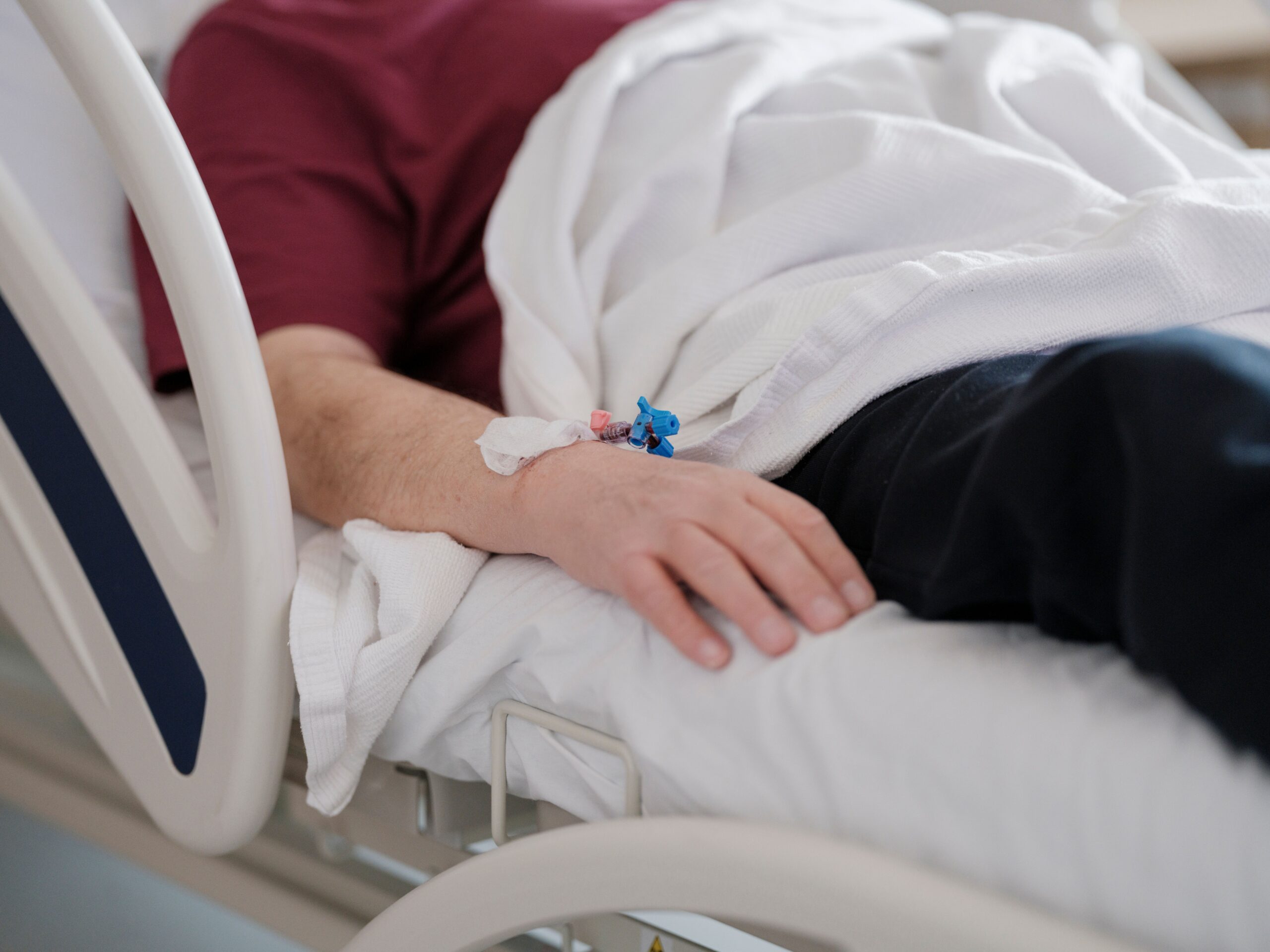 Patient receiving medically supervised IV therapy in a clinical setting.