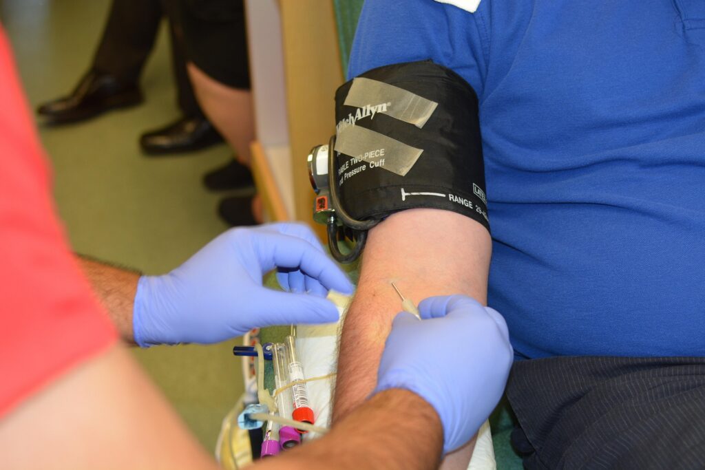 Healthcare professional collecting a blood sample from a patient for routine laboratory testing.