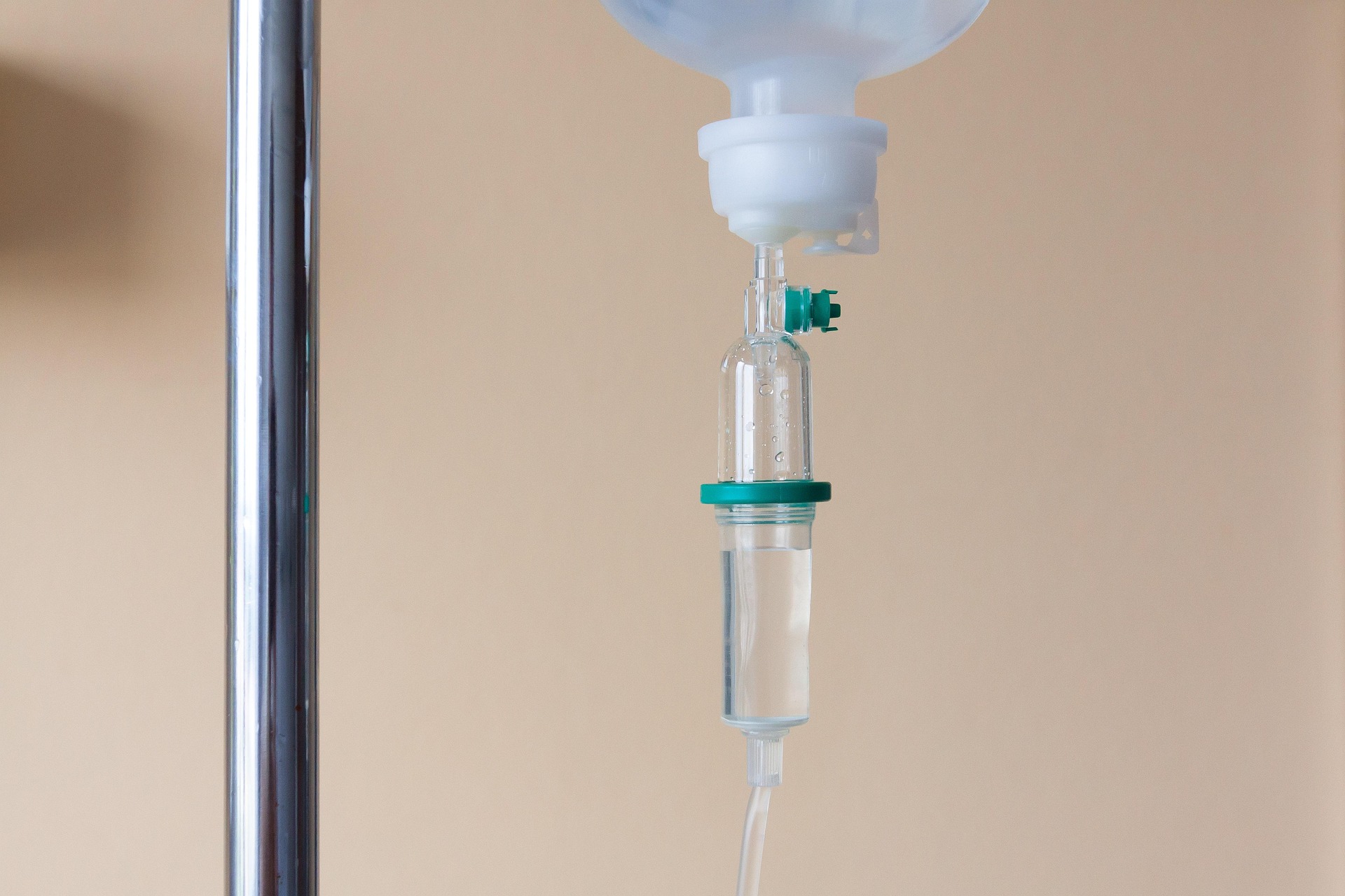Close-up of an intravenous (IV) drip chamber used to administer fluids and medications in a hospital.