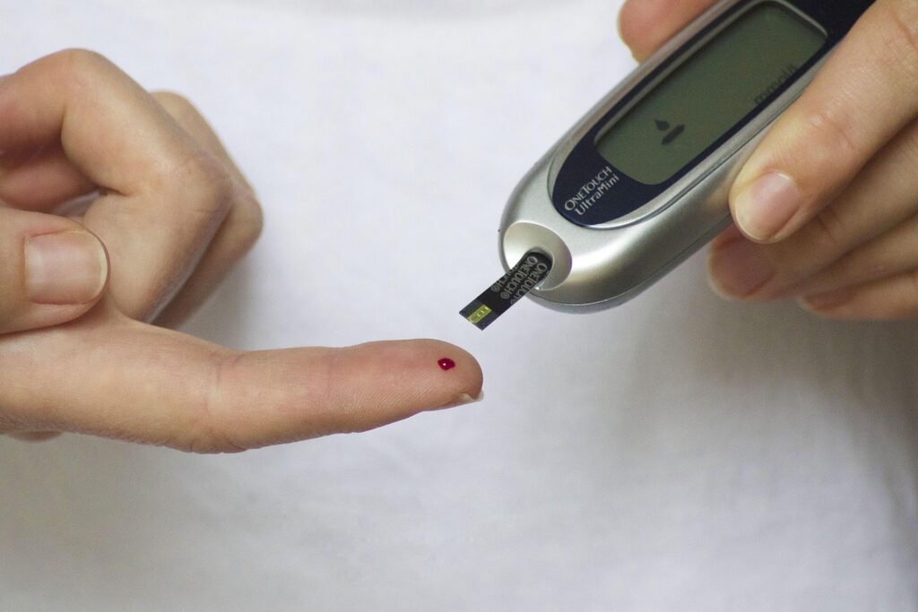 Person checking blood sugar with a glucose meter during diabetes monitoring