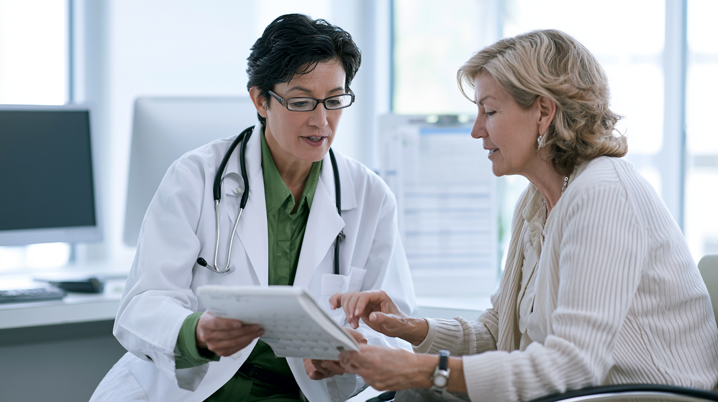 Primary care doctor reviewing health information with an older woman during a routine medical appointment.